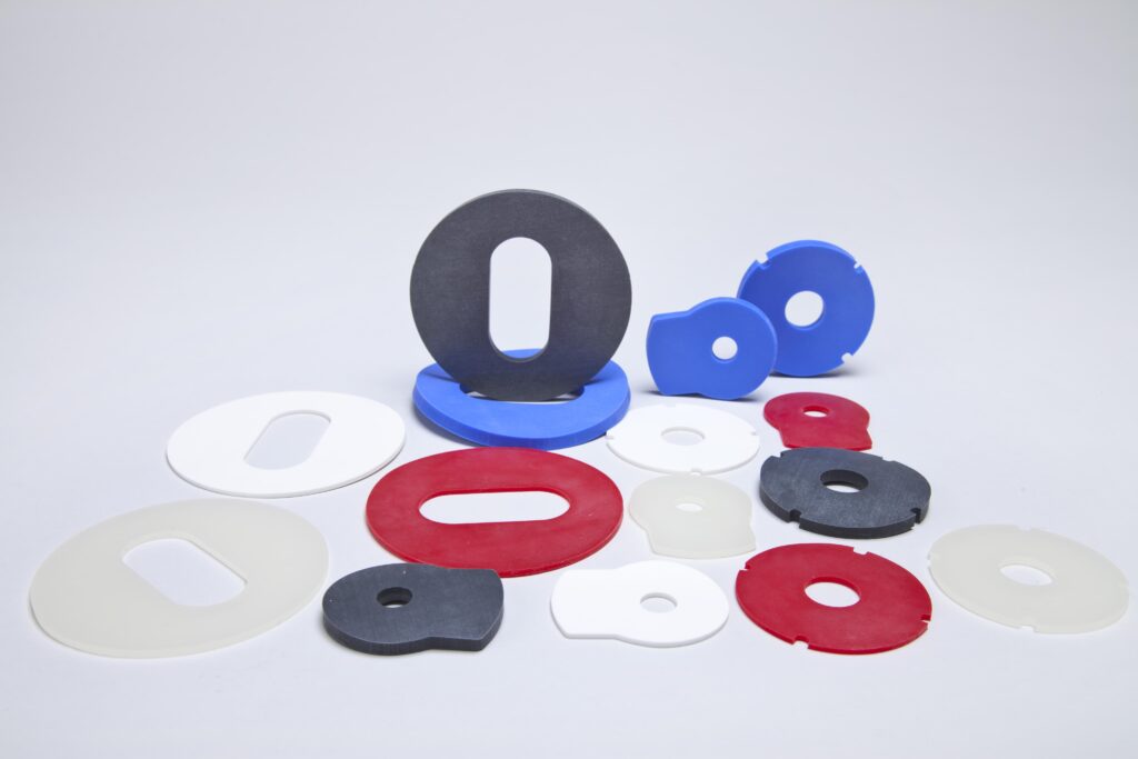 Silicone Rubber Gaskets 4.min - Silicone Rubber in the Energy Generation Industry - Viking Extrusions Several silicone rubber gaskets of different thicknesses lie on a white background.