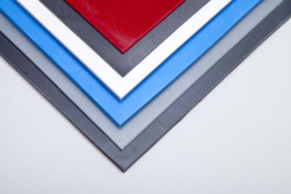 A stack of silicone rubber sheets in a variety of colours, thicknesses, and sizes.