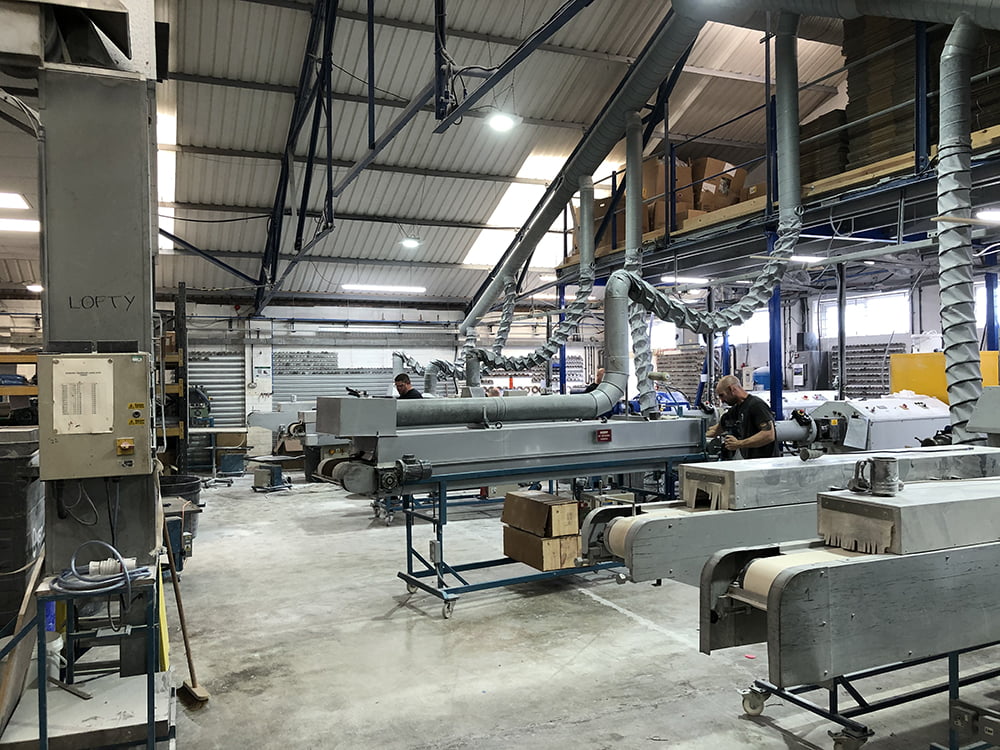 A warehouse filled with rubber manufacturing machinery.