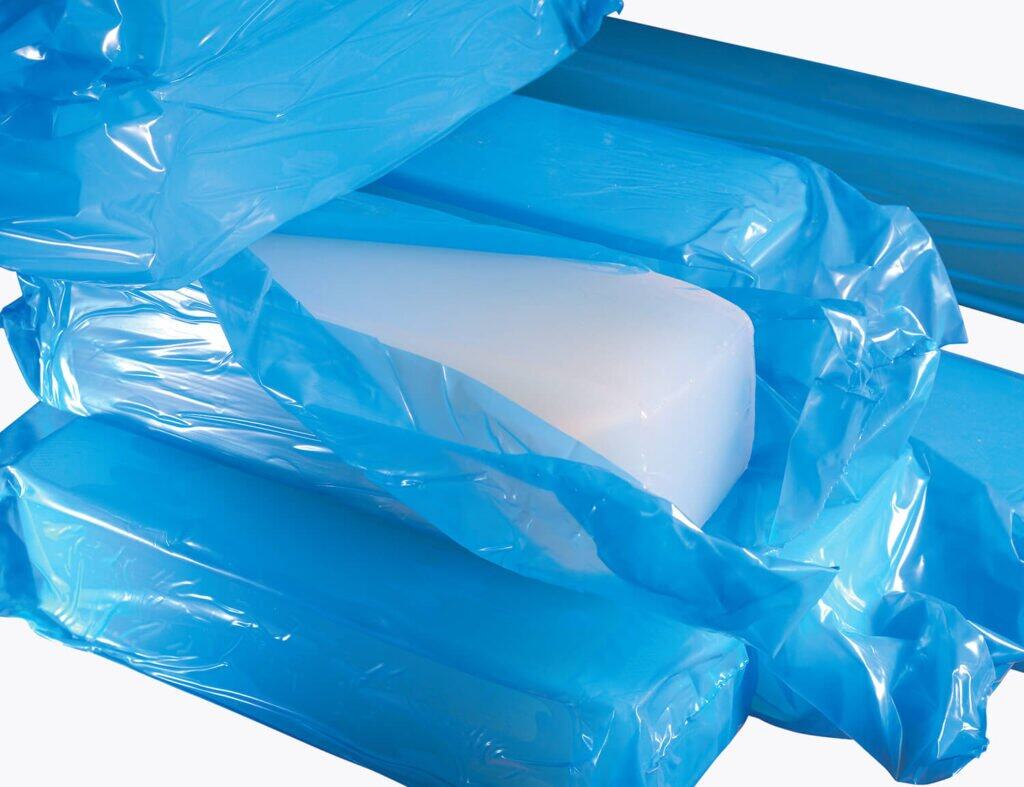 Silicone materials, wrapped in blue plastic, stacked on top of each other.