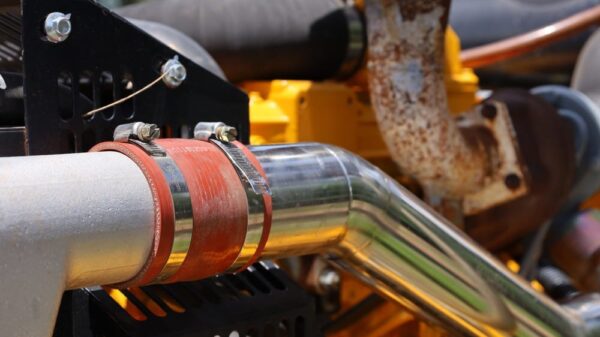 A silicone hose attached to a metal pipe for an agricultural engine.