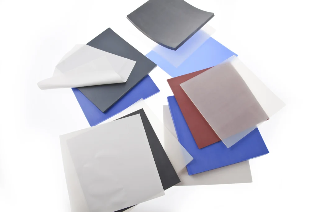 Multiple piles of differently coloured, general purpose FDA silicone sheets.