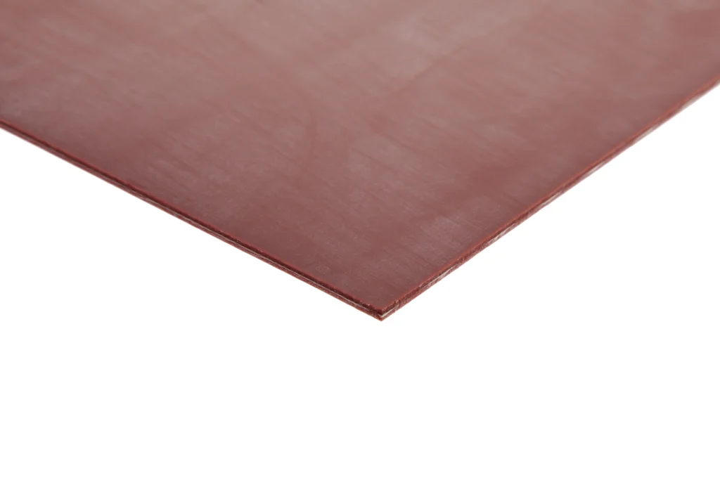 The corner of a red piece of glass fibre reinforced silicone sheeting.