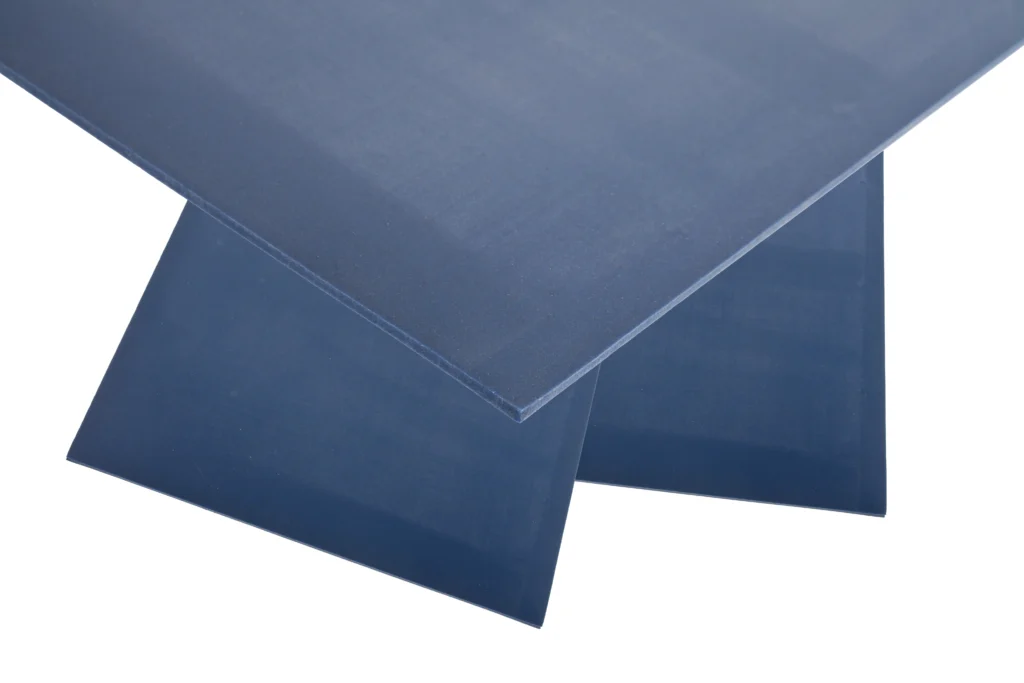 A pile of metal detectable silicone sheeting on top of a white background.